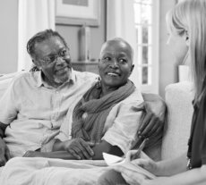 elderly couple talking to a social worker