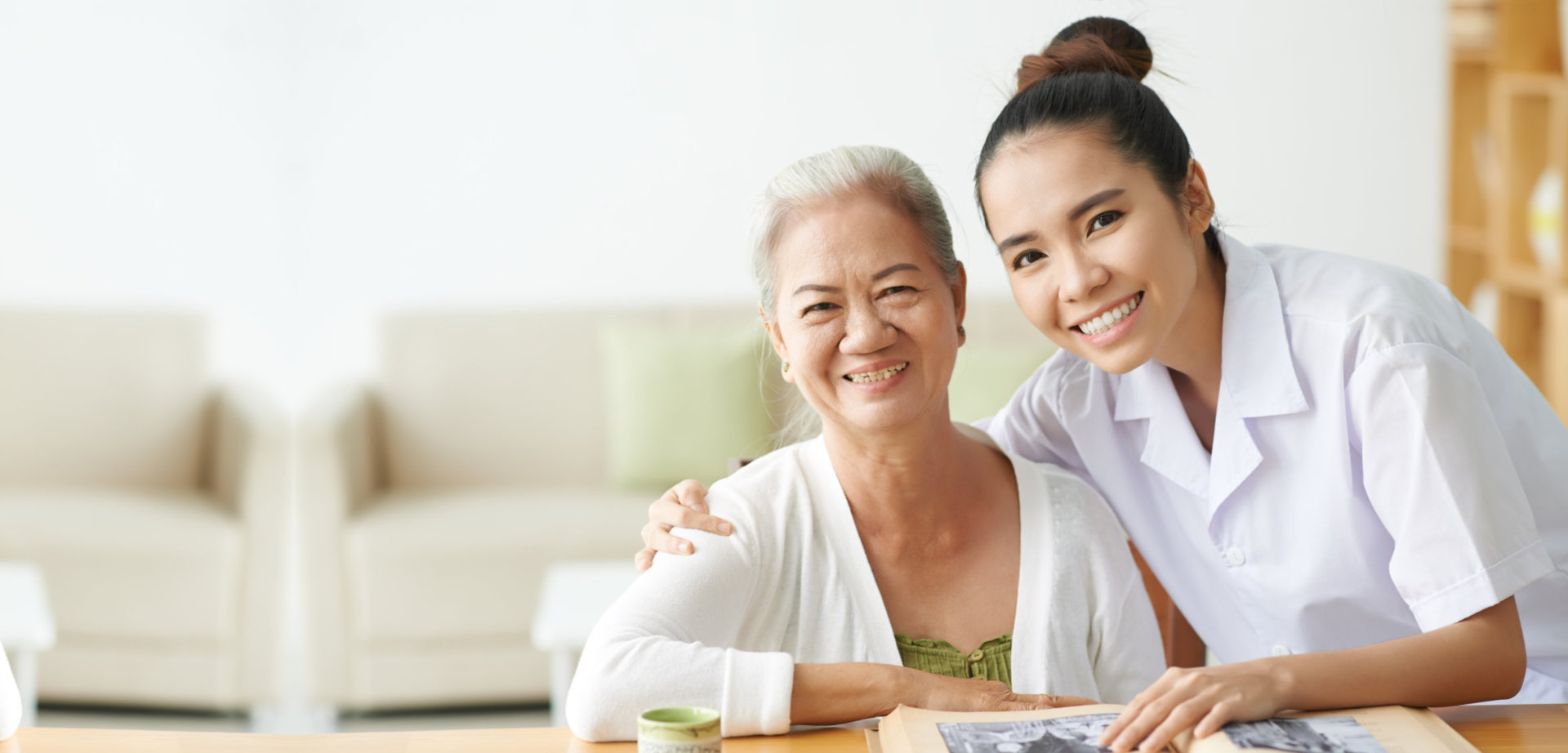 caregiver with elder woman smiling