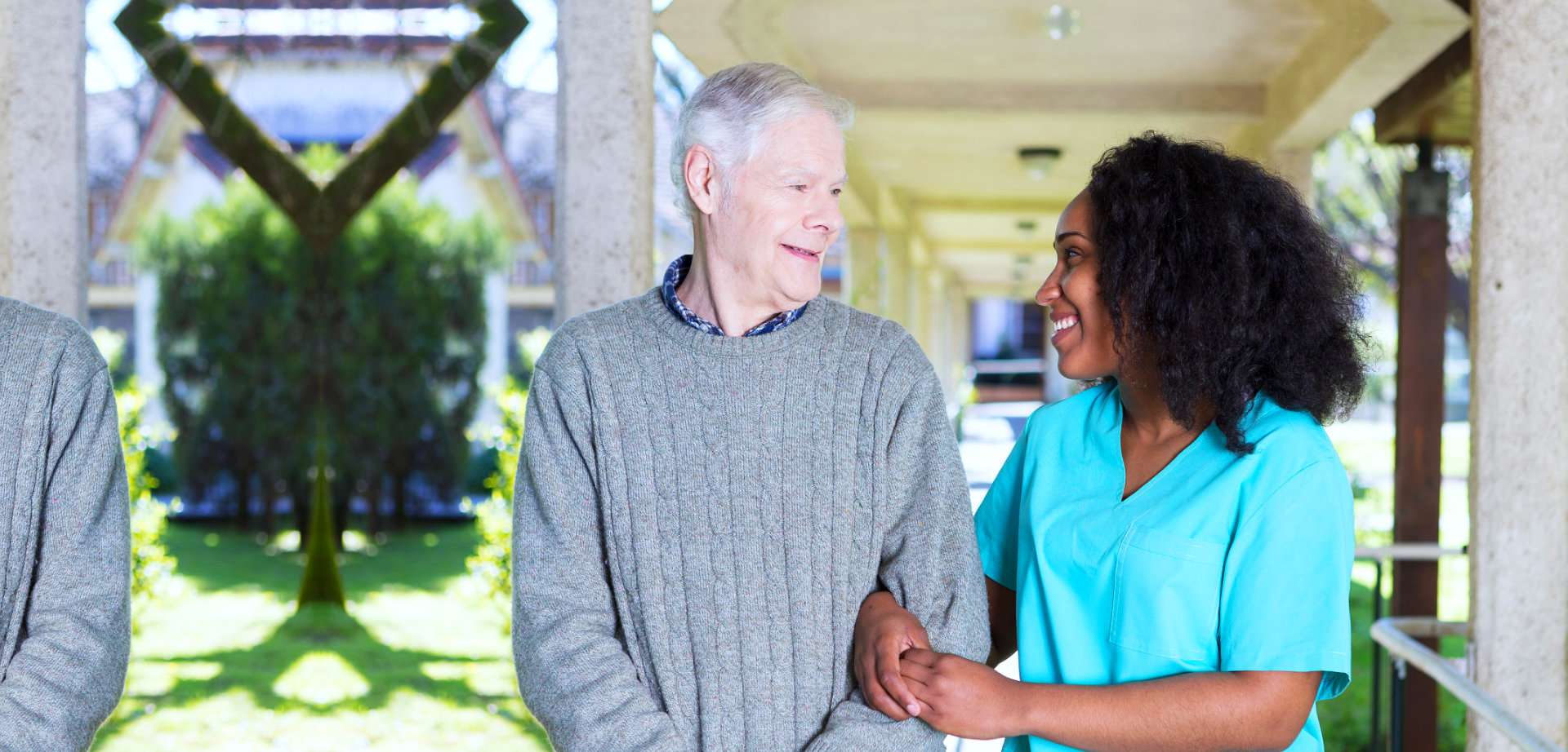 elder man with caregiver outdoors