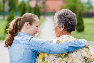 elder woman with caregiver outdoors